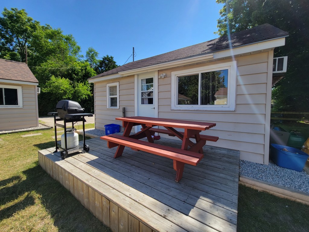 Cottage 3 exterior with picnic table and BBQ